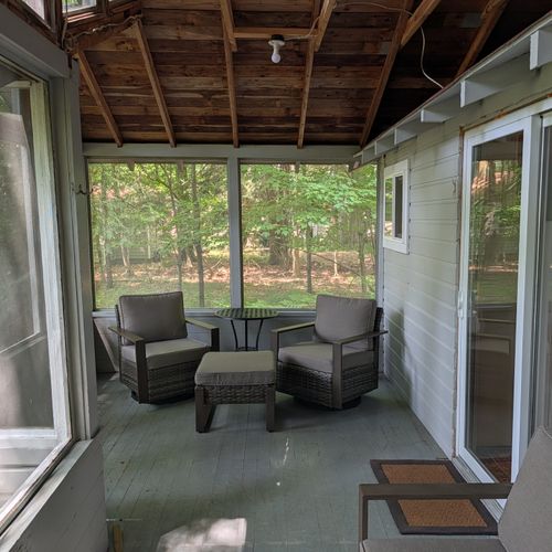 FRONT PORCH: The spacious screened-in front porch offering comfy furniture to relax