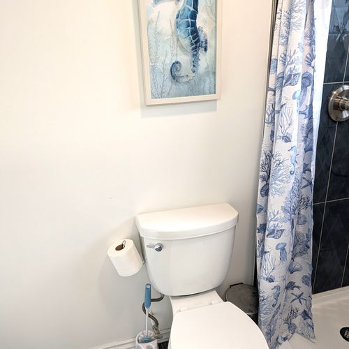 BATHROOM #1 (MAIN FLOOR):  Full bathroom on the main floor that features a wonderfully relaxing rain shower!
