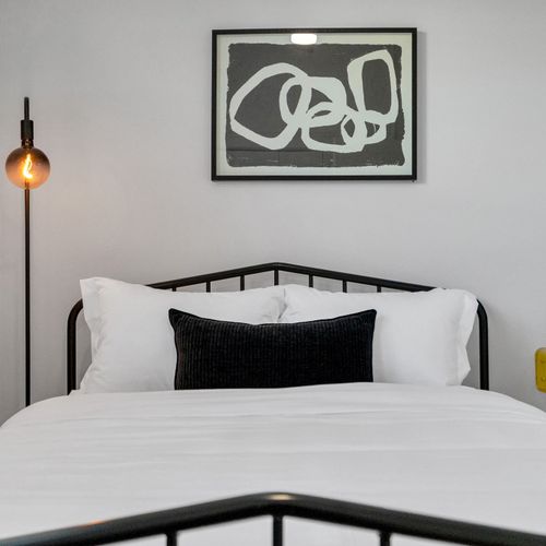 Slip into crisp white linens & a cozy accent pillow for a restful night