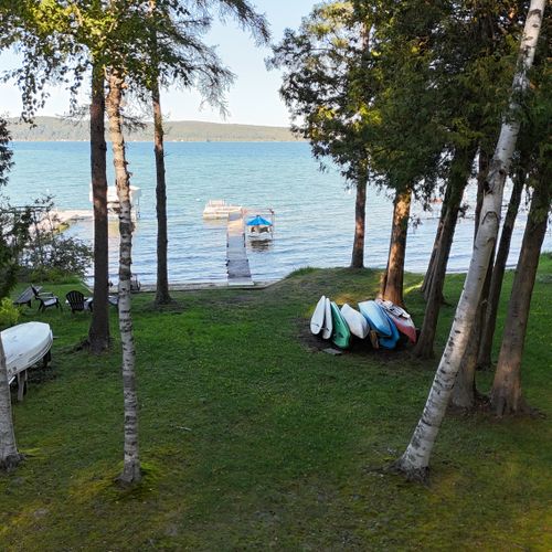 EXTERIOR:  Aerial photo of the private dock, beach, bonfire ring (at the left), and the kayaks and paddleboards (on the right) that are available for guest usage.