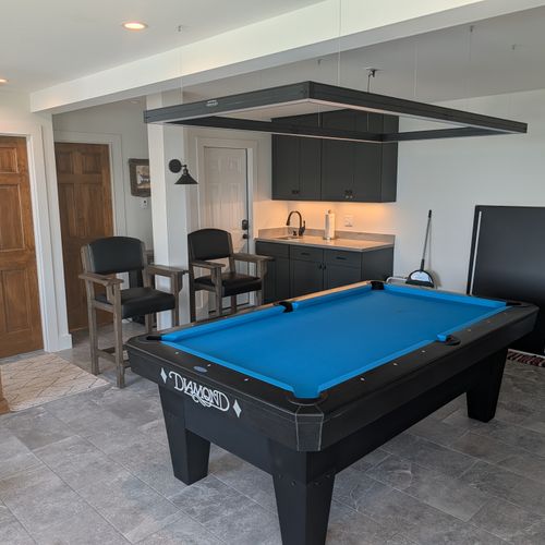GAME ROOM (FIRST FLOOR):  The home has an amazing game room on the first floor that features a deluxe championship pool table as well as a wet bar and great views of Crystal Lake!