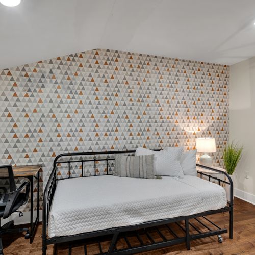 Daybed nook against a statement patterned wall