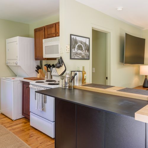Enjoy a full kitchen with a refrigerator, freezer, oven, stove, microwave, dishwasher, coffee maker with complimentary coffee essentials, blender, rice maker, toaster, kettle, cookware, bakeware, dishes, cutlery, and wine glasses.