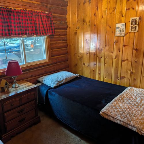 BEDROOM #2:  Features 2 twin size beds, nightstand, lamp, closet, dresser, and luggage stand