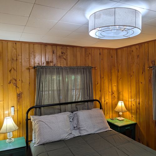 BEDROOM #1:  Includes a queen-size bed, nightstands, lamps, a dresser, and a mirror.
