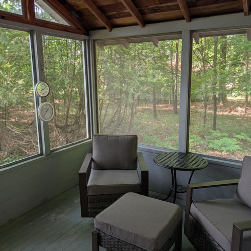 FRONT PORCH: The cute front porch which offers a beautiful view out to the surrounding woods