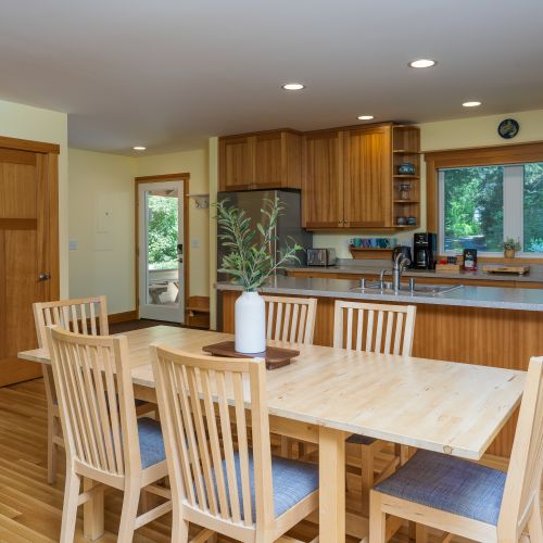 Gather around the dining table or cook with ease in the fully equipped open kitchen. The spacious layout, large island, and ample counter space make it perfect for shared meals and spending time together.