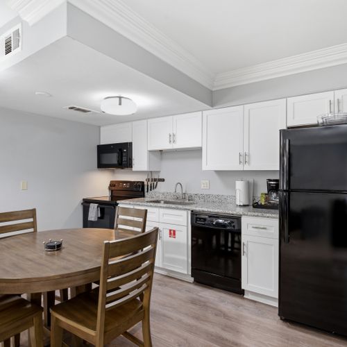 Fully equipped kitchen & dining area in Unit 202, ready for home-cooked meals.
