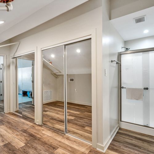 Mirrored closets and a walk-in shower