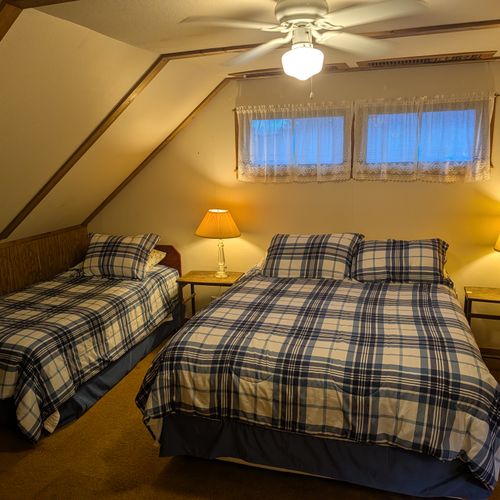 LOFT (SECOND FLOOR):  The home has a large upstairs open loft area that includes 3 full-size beds and a twin bed, thus sleeping up to 7 people in the loft area.
