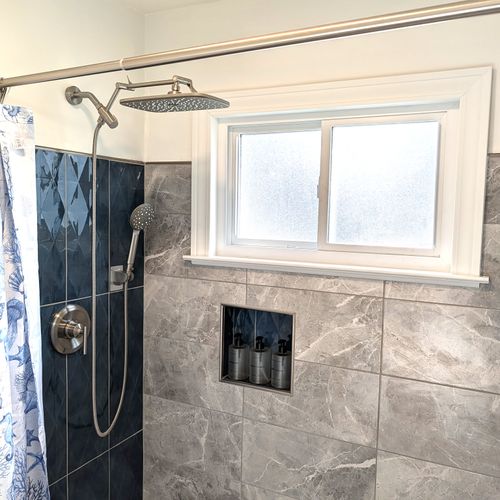 BATHROOM #1 (MAIN FLOOR):  Full bathroom on the main floor that features a wonderfully relaxing rain shower!