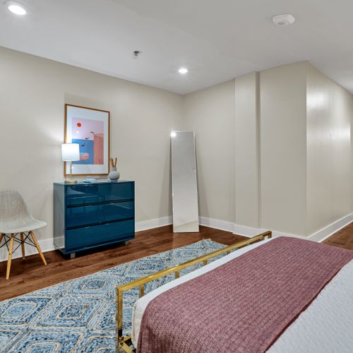 Spacious bedroom with a vibrant teal accent