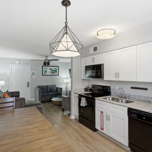 Bright kitchen & dining nook w/ modern pendant lighting — great for casual meals at home.