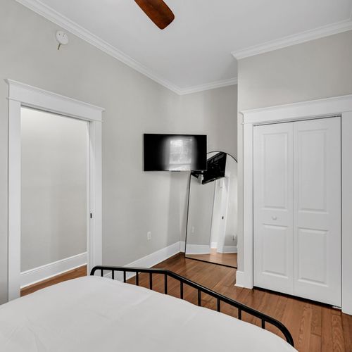 Catch a show in bed w/ the wall-mounted TV, plus a roomy closet for your things