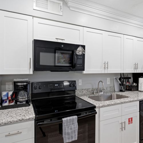 Well-equipped kitchen w/ full appliances & a sink ready for home cooking.