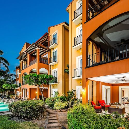 Contemporary beachfront building design with ocean view balconies at luxury Playa Langosta condo, Tamarindo, Costa Rica. Multiple private balconies overlooking pool, tropical gardens, and Pacific Ocean. Steps from surf and restaurants.