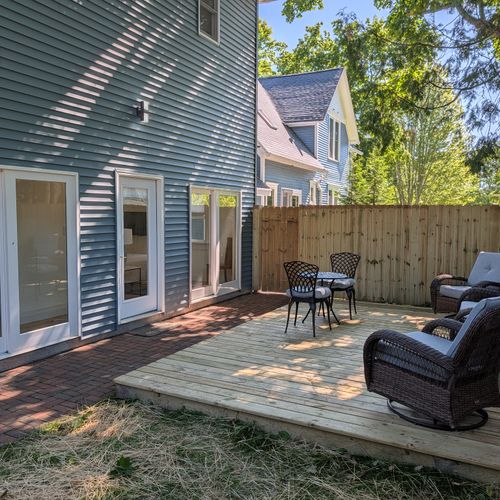 EXTERIOR: The cute fenced-in backyard with plenty of seating. Fun and relaxing times found here!