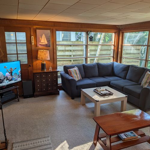 MAIN LIVING ROOM (FIRST FLOOR):  The home has a large, cozy, and comfortable living room on the main floor.  Note that the wood fireplace is available for guest usage.