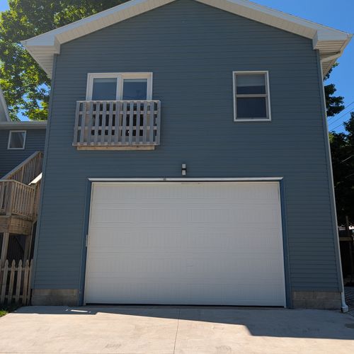 EXTERIOR: The free parking on the premises is next to the garage on the right. The garage itself is not for guest use. On the opposite side of the garage is the cute apartment and its beautiful fenced-in backyard. The owner above will not bother you