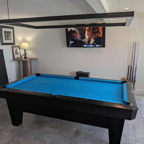 GAME ROOM (FIRST FLOOR):  The home has an amazing game room on the first floor that features a deluxe championship pool table as well as a wet bar and great views of Crystal Lake!