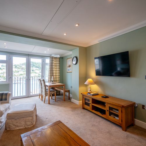 Cosy living area with french windows for a gorgeous view of the river dart.