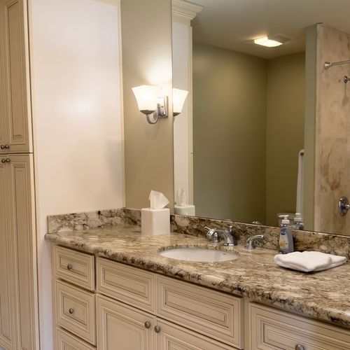 Bathroom w/ double vanity, granite counters & walk-in shower