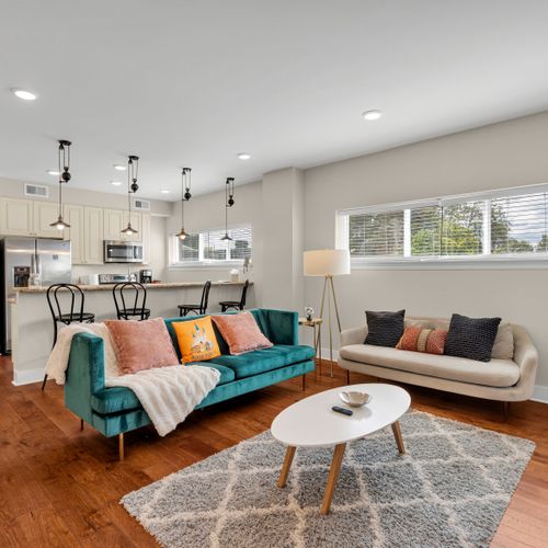 Bright open living under sleek pendant lights