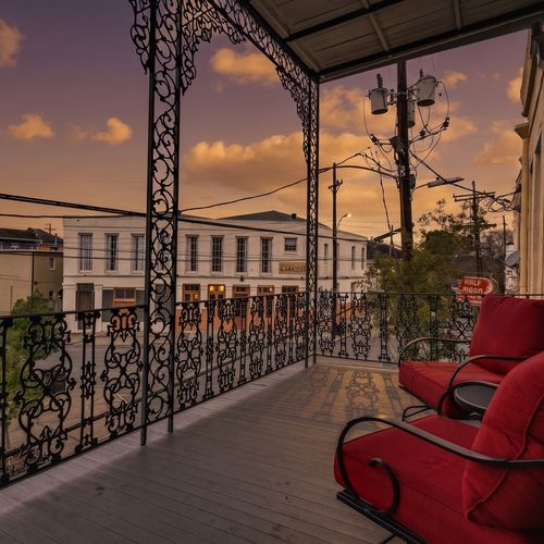 Take in the views from your private balcony w/ cozy red chairs