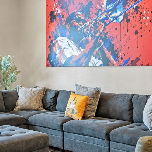 Deep gray sectional under a burst of bold color gallery-sized art