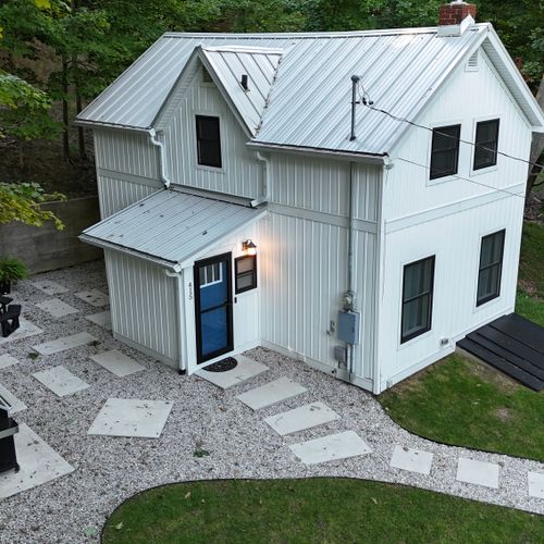 EXTERIOR:  Another aerial photo of the property, highlighting the propane grill and the outdoor dining table.