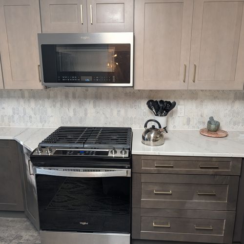 KITCHEN (SECOND FLOOR):  Large modern kitchen with a portal island and all appliances including a dishwasher and microwave.