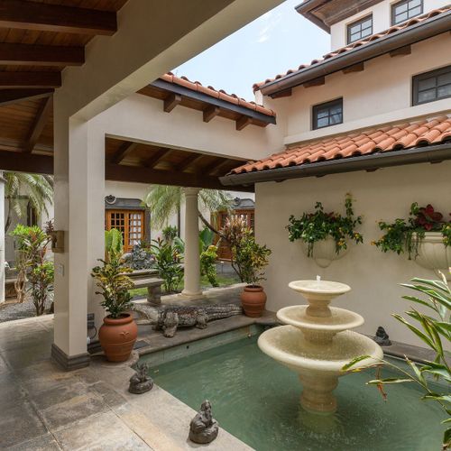 Quiet interior courtyard with a tiered stone fountain - the calm center of the estate.