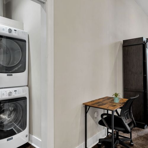 Laundry and a work desk tucked side by side