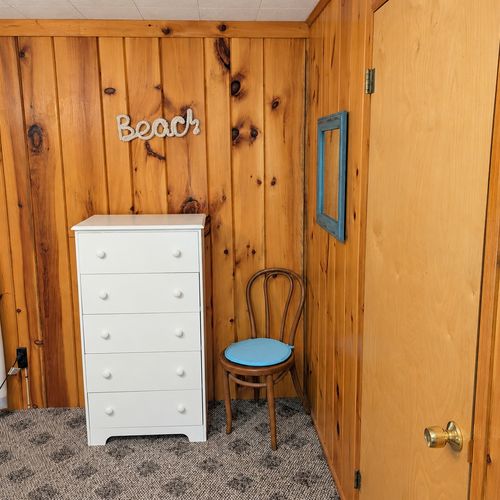 BEDROOM #1:   Features a queen-size bed, nightstands, lamp, dresser, closet, and chair.