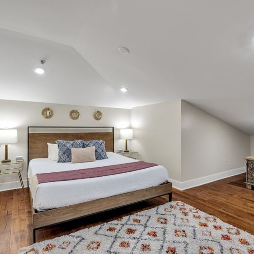 Rustic wood headboard under a vaulted ceiling