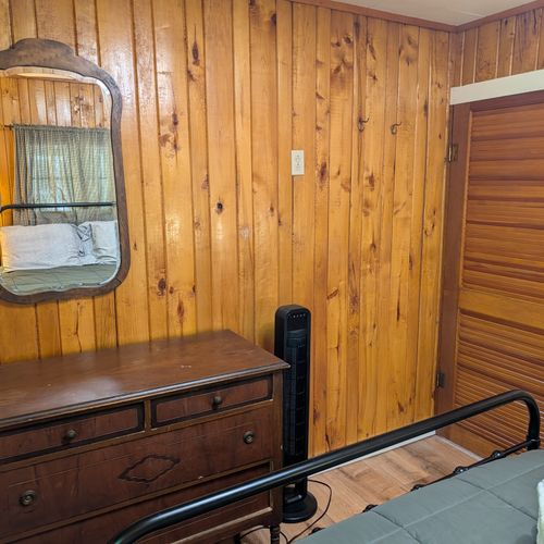 BEDROOM #1:  Includes a queen-size bed, nightstands, lamps, a dresser, and a mirror.