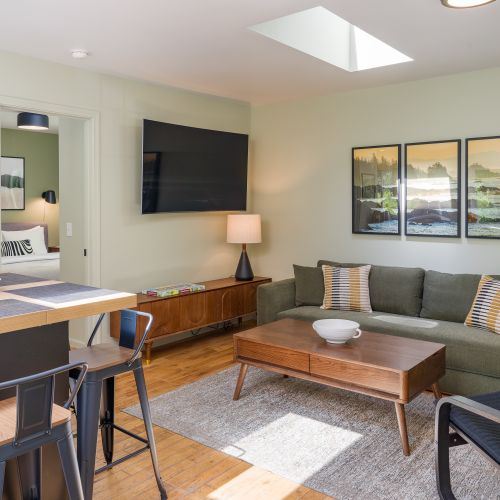 Bright and inviting living area with comfortable seating, entertainment, and seamless flow to the kitchen