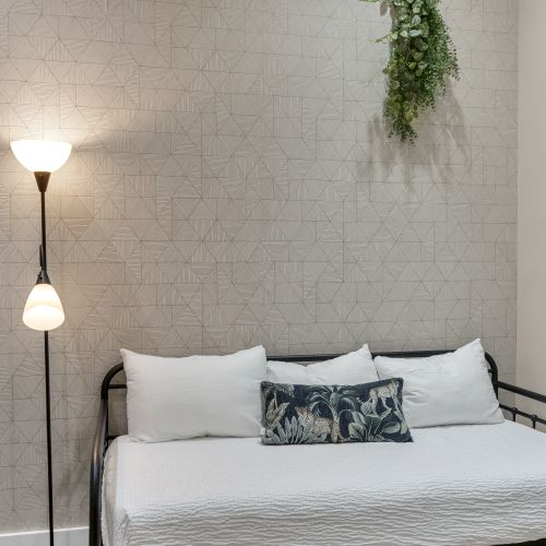 Daybed retreat glowing under a floor lamp