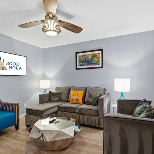 Unit 306 or similar – Cozy lounge area w/ bold accent chairs & a smart TV.