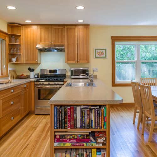 Cook with ease in the fully equipped kitchen featuring a gas range, microwave, coffee maker, electric kettle, toaster, cookware, dishes, utensils, and a spacious island with extra seating—perfect for preparing and sharing meals.