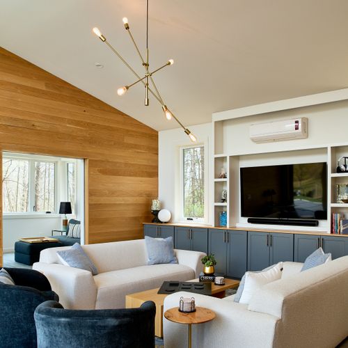 Looking into the pool house living room, with dedicated space for remote work beyond.