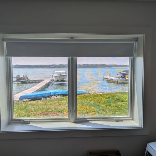 BEDROOM #4 (FIRST FLOOR):  Features a queen-size bed, private A/C unit, ceiling fan, television, dresser, mirror, nightstand, reading lamps, a clothes rack, and great views of Crystal Lake!