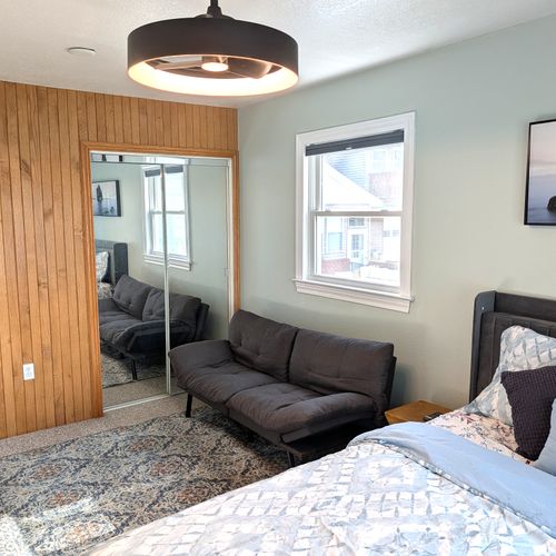 BEDROOM #1 (MAIN FLOOR):  Beautiful bedroom with a great view of Bass Lake, queen-size bed, futon bed, ceiling fan, private television, and private closet.