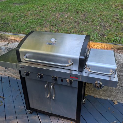 EXTERIOR:  The gas grill on the backyard deck.