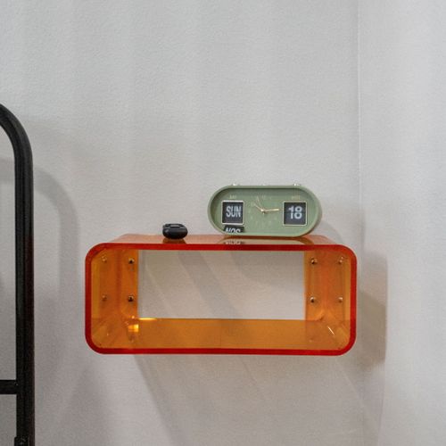 Playful orange floating shelf & retro flip clock add a pop of personality