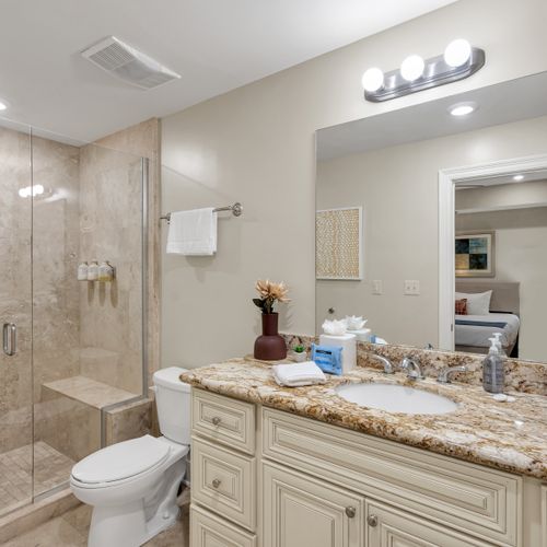 Glass shower and dual-toned stone finishes