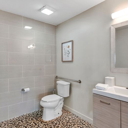 Bright tiled bath with a calm, clean feel