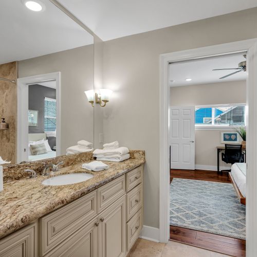 Double vanity with a peek into the bedroom