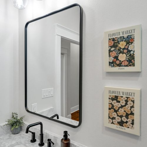 Do a quick outfit check in the full-length mirror next to cheerful floral art