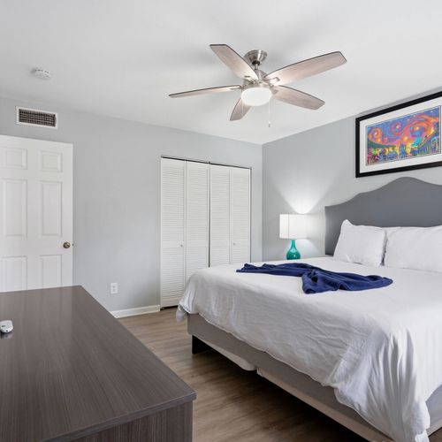 Cozy king bedroom w/ Smart TV & soft linens — ideal for winding down in comfort.